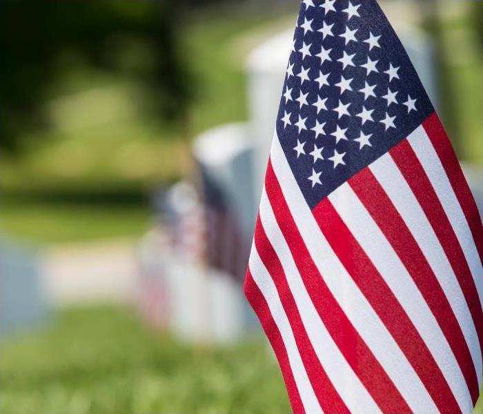 An American flag on a grave site to celebrate memorial day