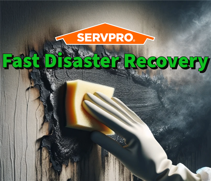 A SERVPRO employee displaying fast disaster recovery by getting rid of soot damage.